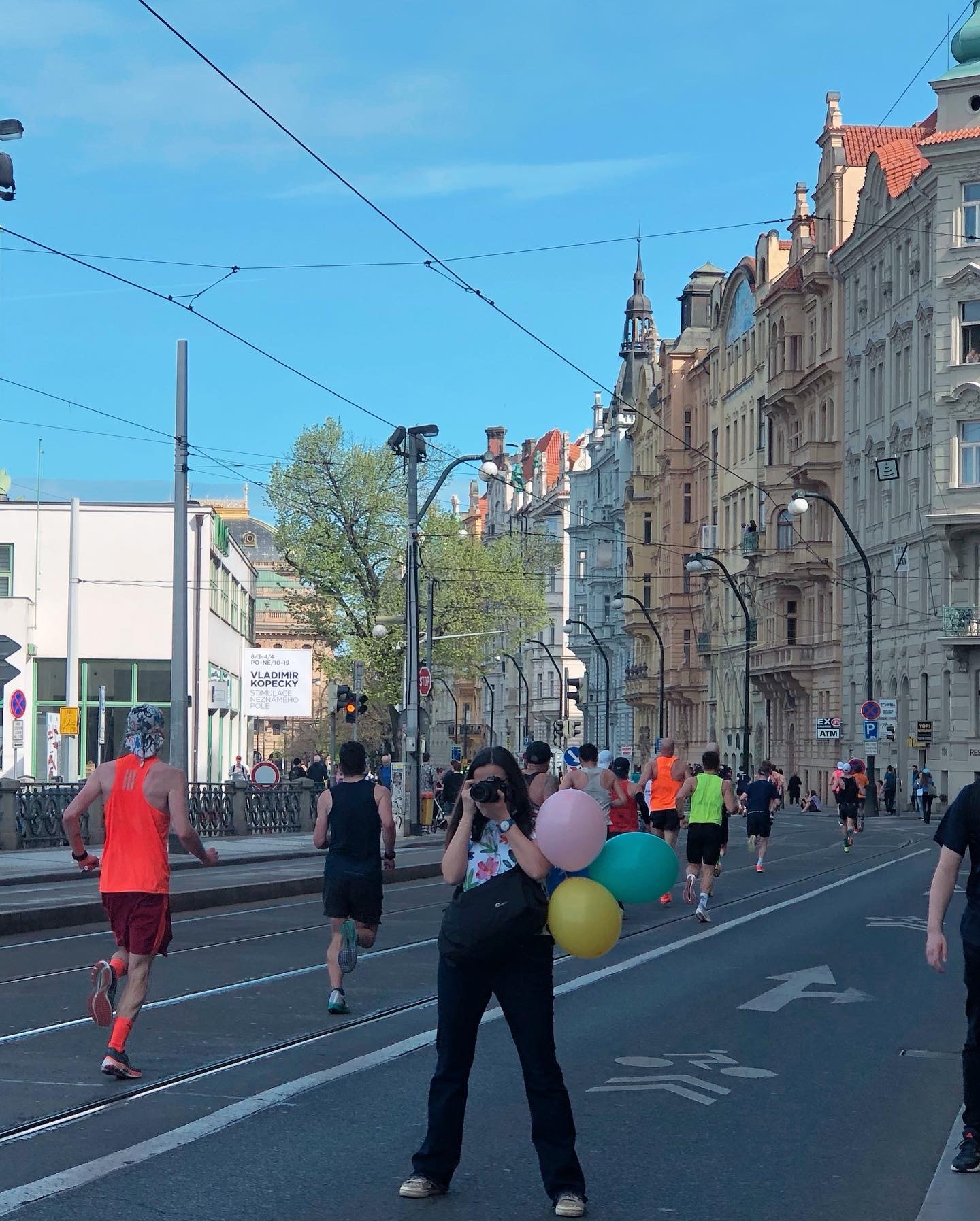 Xi's travel photograph of a street with runners and balloons in Prague