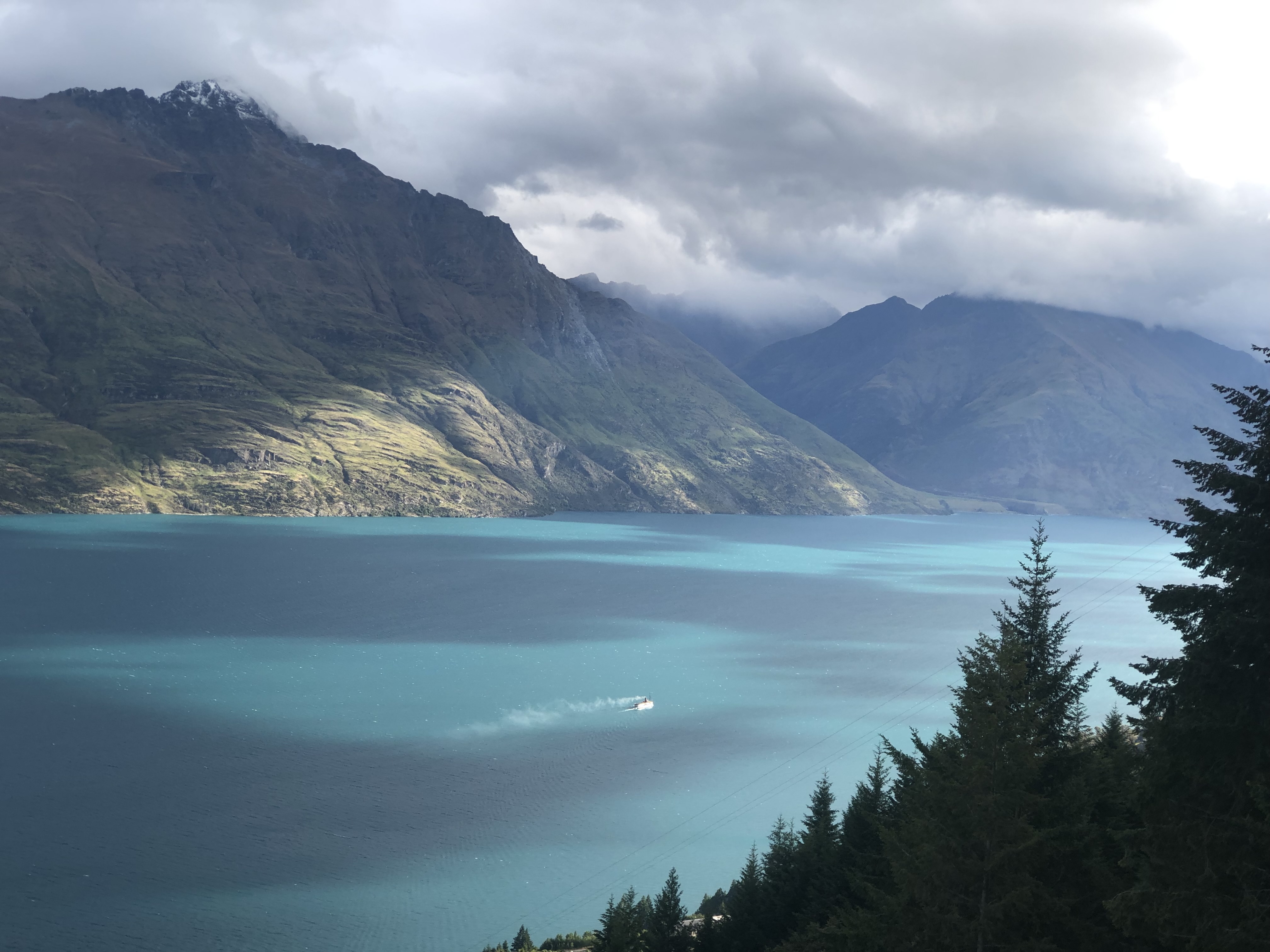 A turquoise lake beneath dramatic mountains in New Zealand